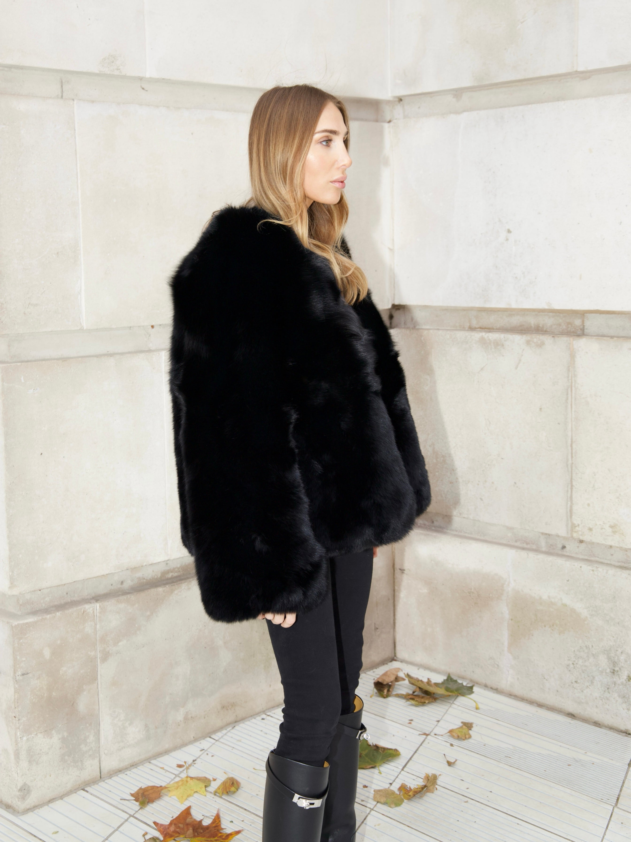 Side view of The Anouska black natural fox fur coat showing its thick fur texture and relaxed shape