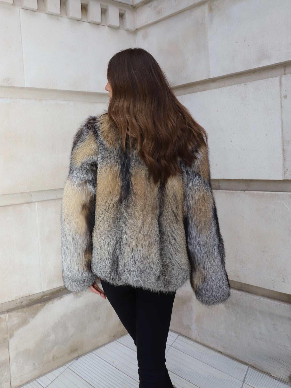Grey and golden fox fur coat back view showing medium length, oversized sleeves and natural fox fur pattern.