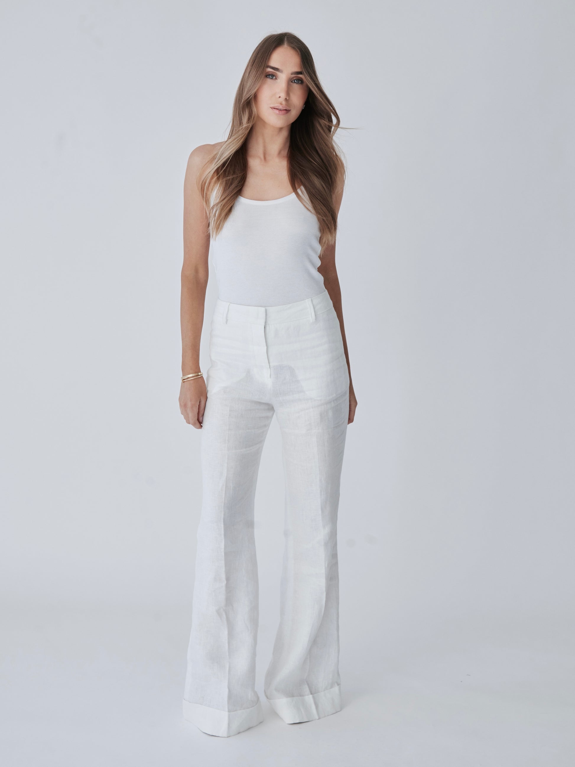Lucia Pant in white linen with high waist and wide-leg silhouette, front view.