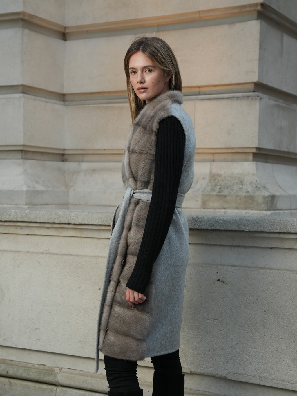 Side view of The Vera Mink Gilet in grey, styled as an elegant autumn winter layering piece