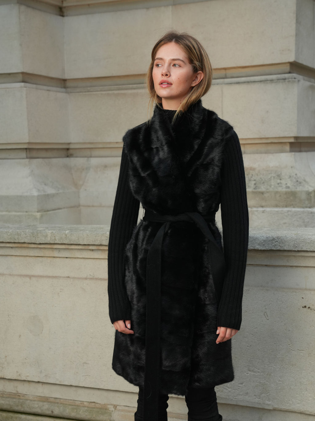 Close-up of The Vera black mink fur gilet by L.CUPPINI styled over a black knit