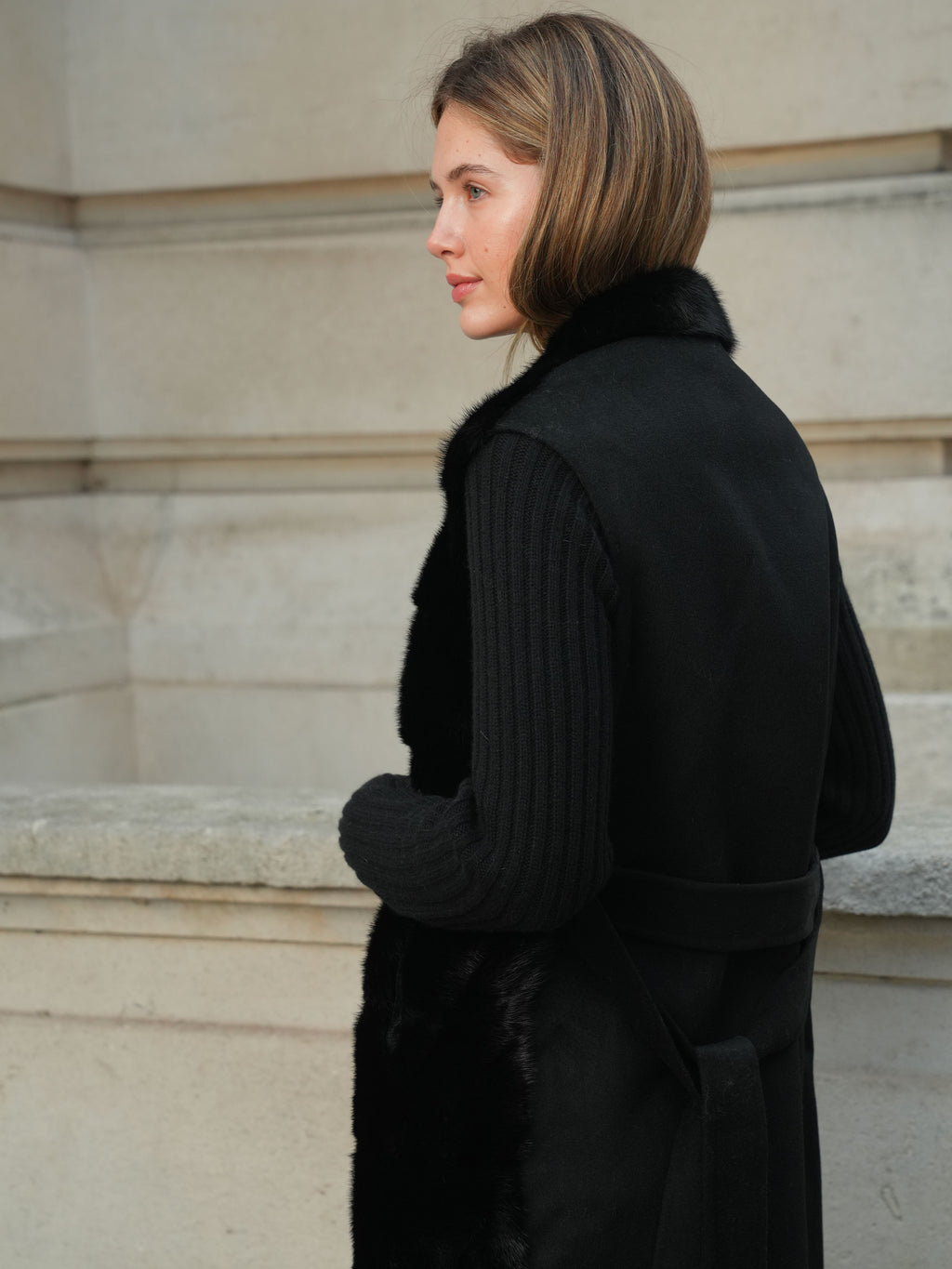 Side view of The Vera black gilet showing mink fur front and sleeveless silhouette