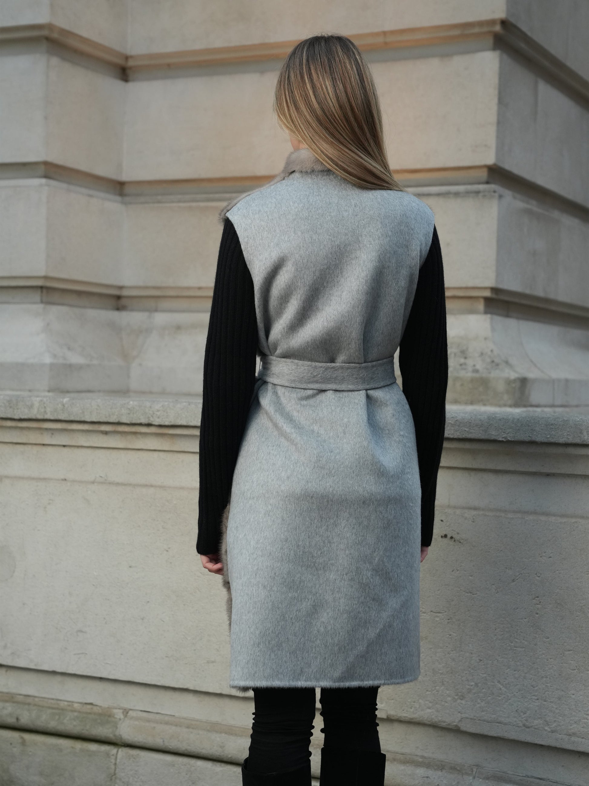 Back view of The Vera grey mink gilet showing the cashmere wool blend back and belted silhouette