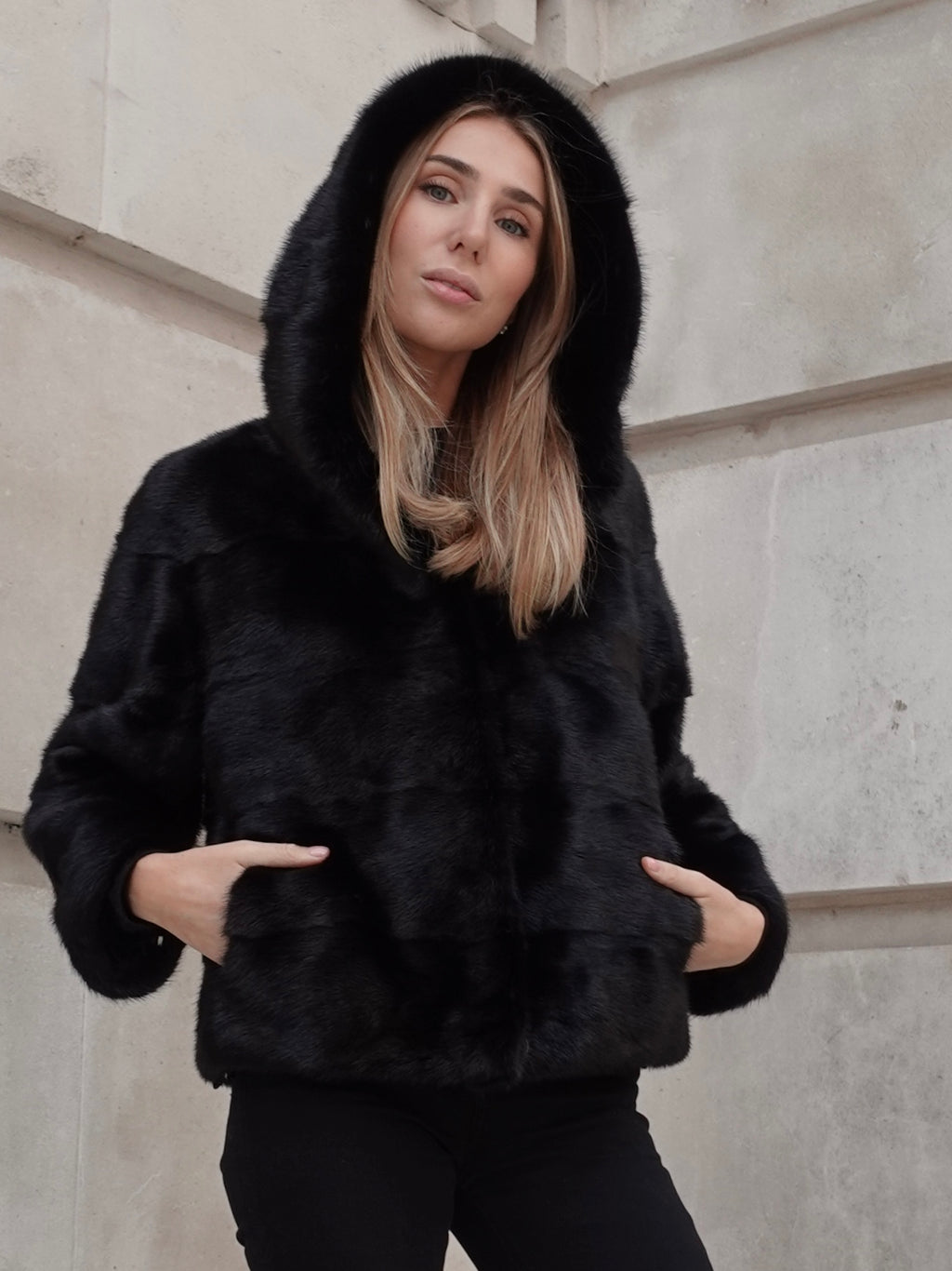 Front view of The Alexandra black mink fur coat with hood and slightly relaxed fit