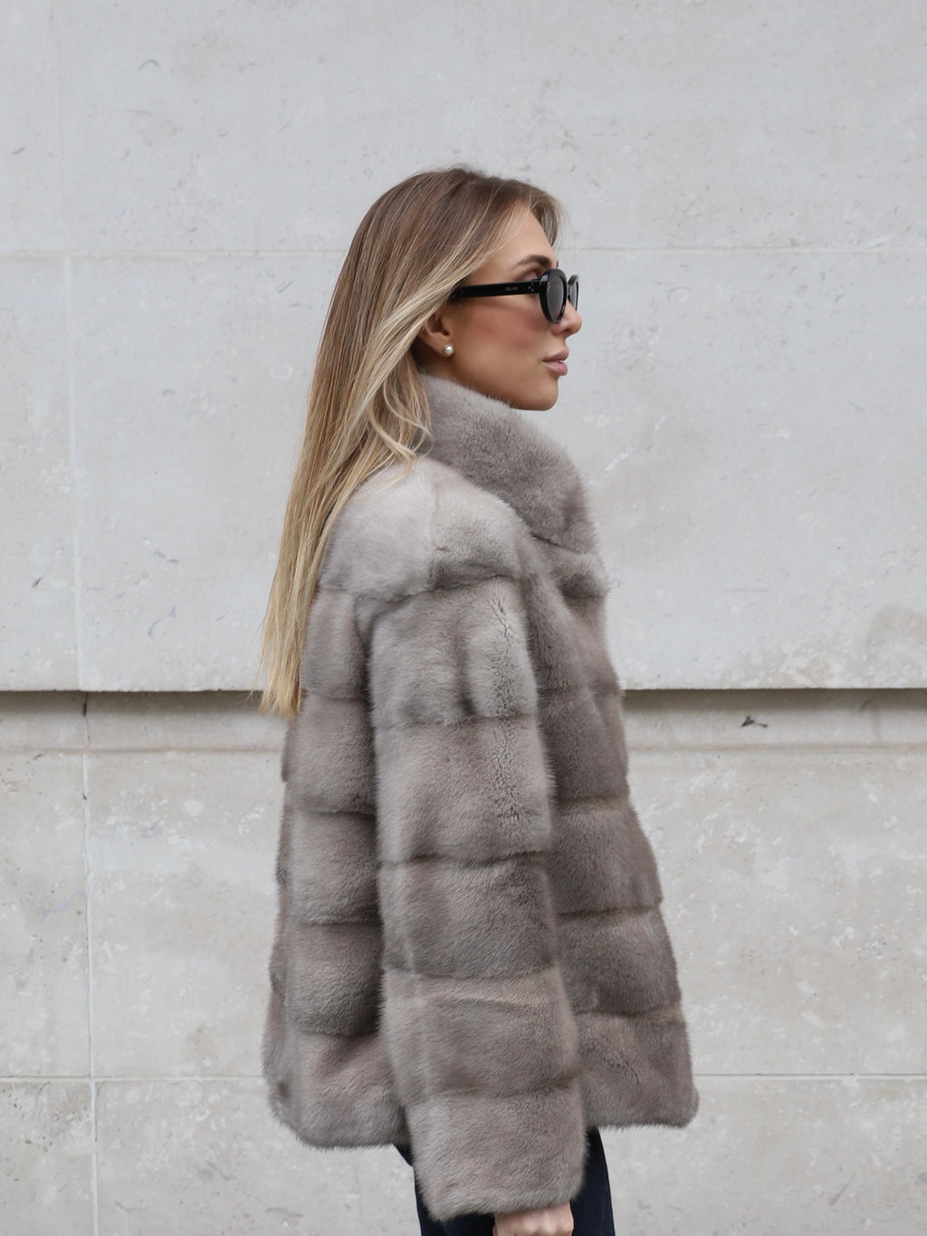Side view of The Alexandra grey mink fur jacket showing its relaxed fit and soft fur texture