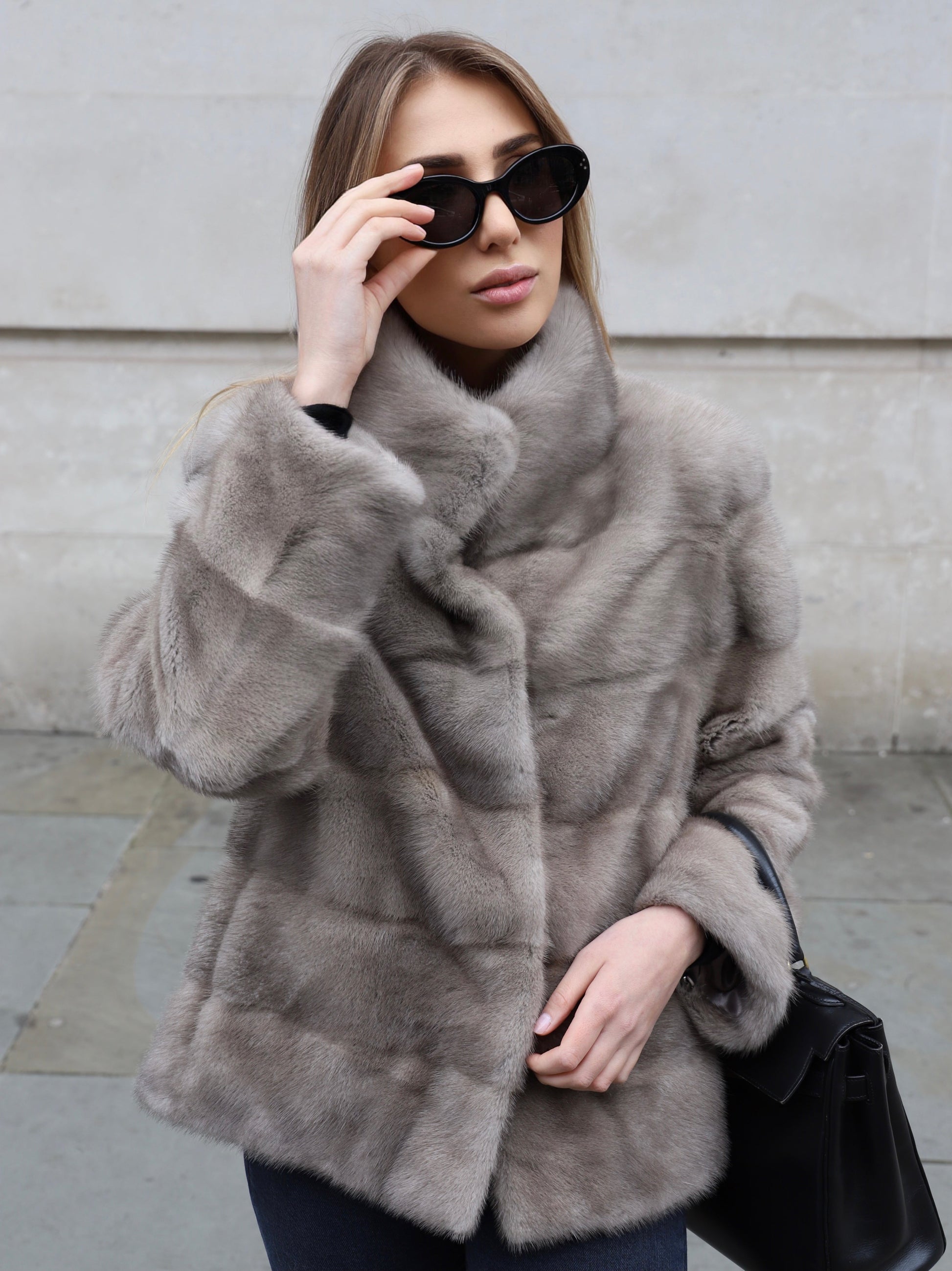 The Alexandra grey mink jacket by L.CUPPINI styled with sunglasses and a black handbag